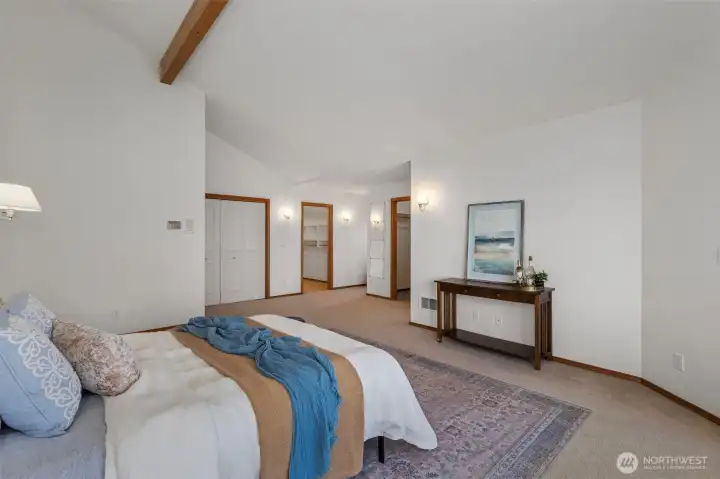 Another shot of the upper level primary looking on to closets and entrance to 5 piece primary bath.