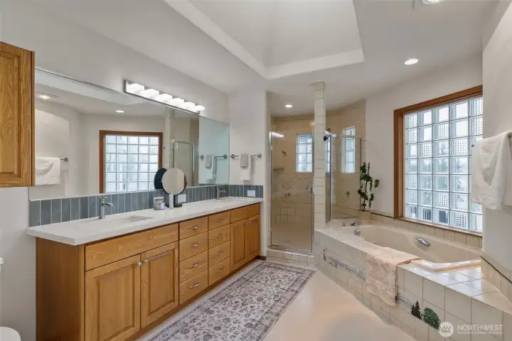 Upper level primary with new quartz counter, backsplash and lighting. Skylight just out of shot fills the space with natural light!