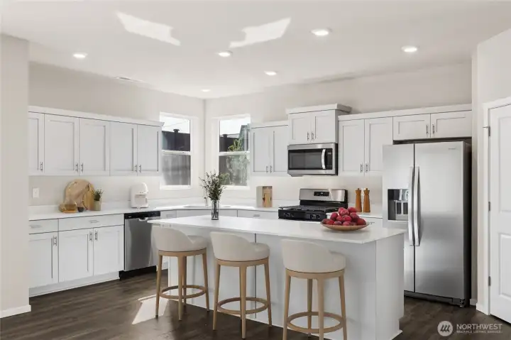 Kitchen offers huge island, stainless steel appliances, painted cabinets and large walk-in pantry. *Finishes and options will vary.