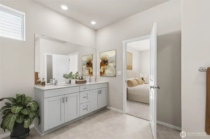 Primary bathroom with double vanity, shower, and walk-in closet that connects to laundry room. *Finishes and options will vary.