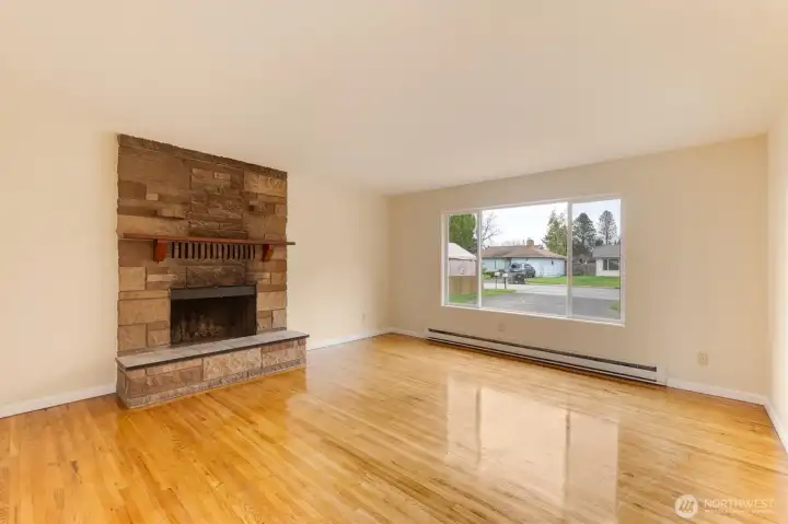 The big bright (vinyl) windows show off the refurbished Hardwood floors