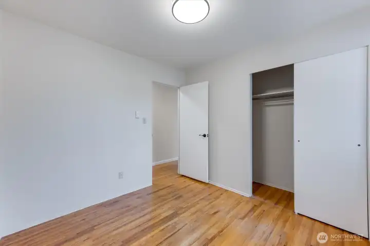 Bedroom 1 w/ door out to hallway