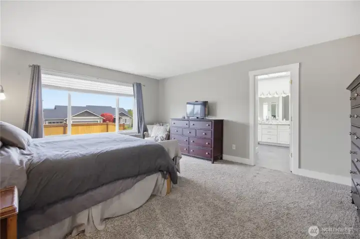 Main floor primary bedroom with en suite bathroom and oversized closet