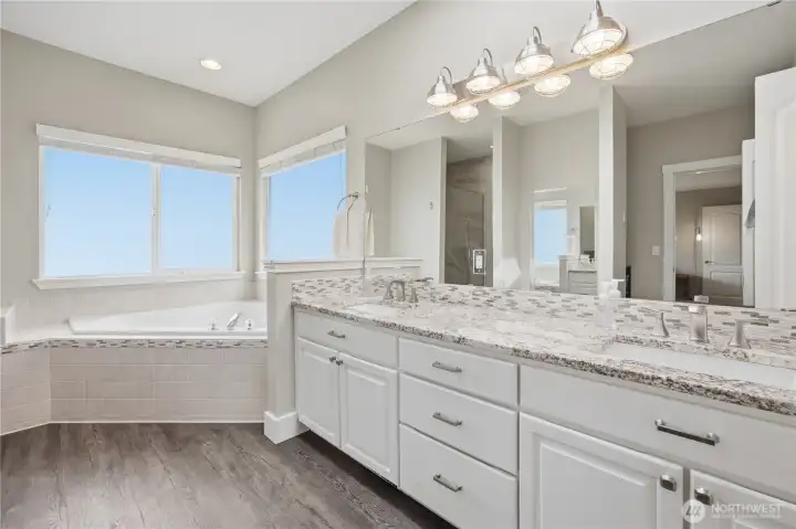 Main floor bathroom located within the primary bedroom on the main floor