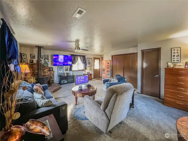 Spacious family room with wood stove, 3/4 bath and access to the side and back yards.