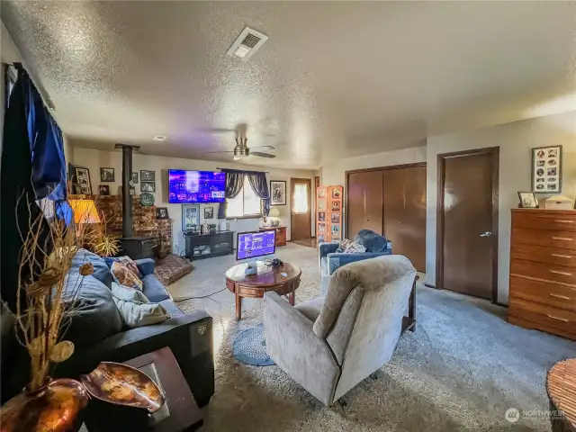 Spacious family room with wood stove, 3/4 bath and access to the side and back yards.