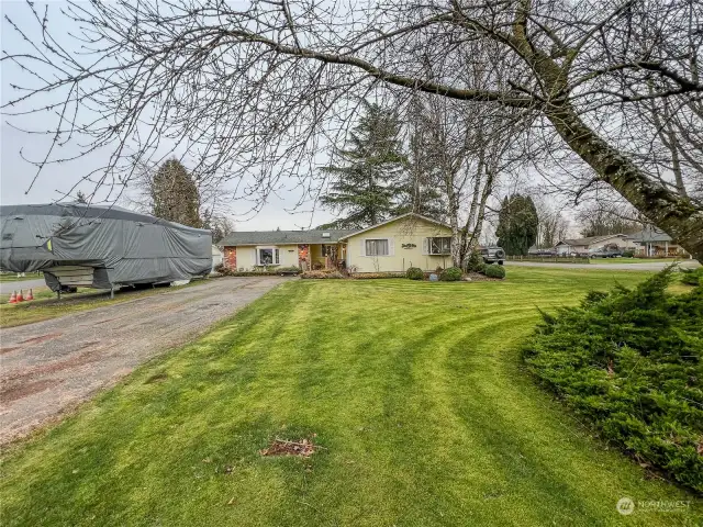 Another view of the home, long driveway for parking and large front and side yard.