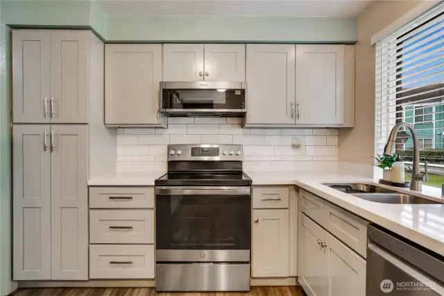 Beautifully upgraded kitchen with newer appliances, counters, tile and custom cabinets!