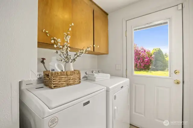 Laundry room area featuring the brand new washer and dryer with access to the backyard. Great for the rainy and muddy days.