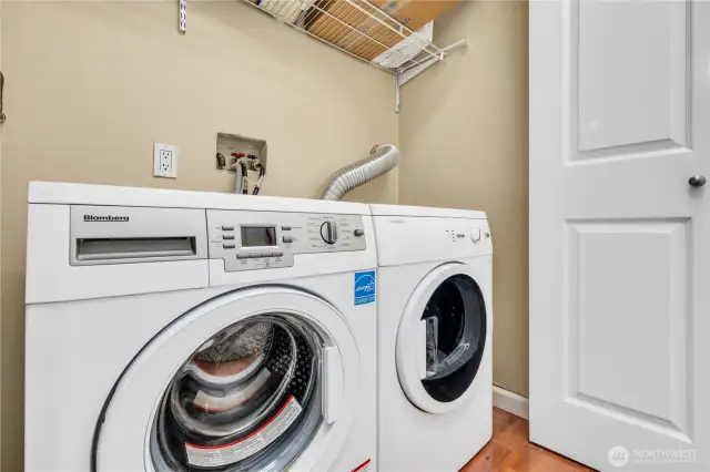 Dedicated laundry area with shelving.