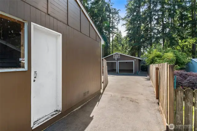 Handy side access leads directly to the backyard, detached garage, and shop—ideal for projects, storage, or easy outdoor access.