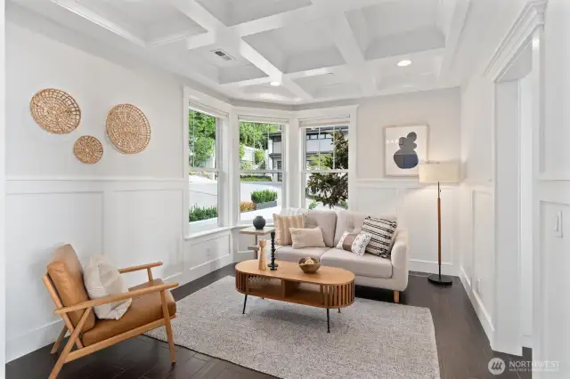 A welcoming flex room off the entry offers a cozy spot for morning coffee, reading, or quiet reflection.
