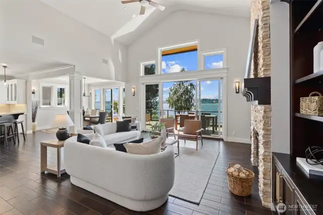 Soaring ceilings and sunlit spaces define the open-concept great room, dining, and kitchen - all oriented toward breathtaking west-facing views.