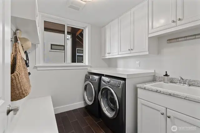 Thoughtfully designed, the main floor features a large laundry room - one of three throughout the home.