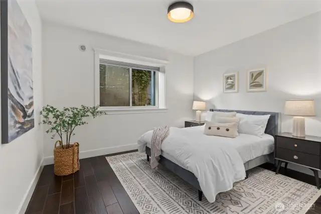 Enjoy ample storage and warmth in the lower-level bedroom, featuring generous closets and radiant heating.