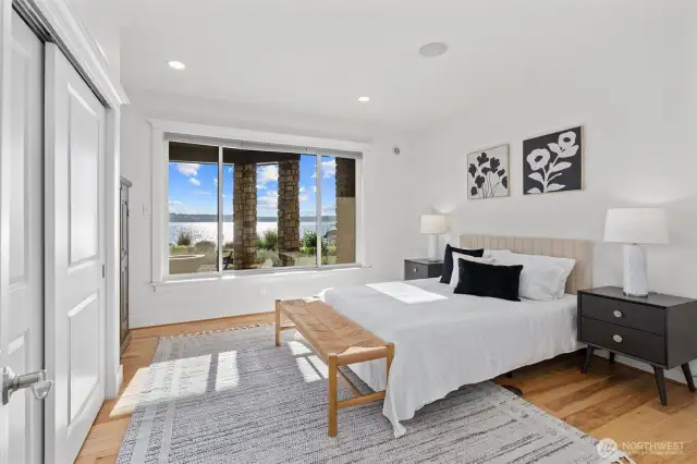 This spacious lower-level bedroom is filled with natural light and captures stunning lake views from oversized windows.