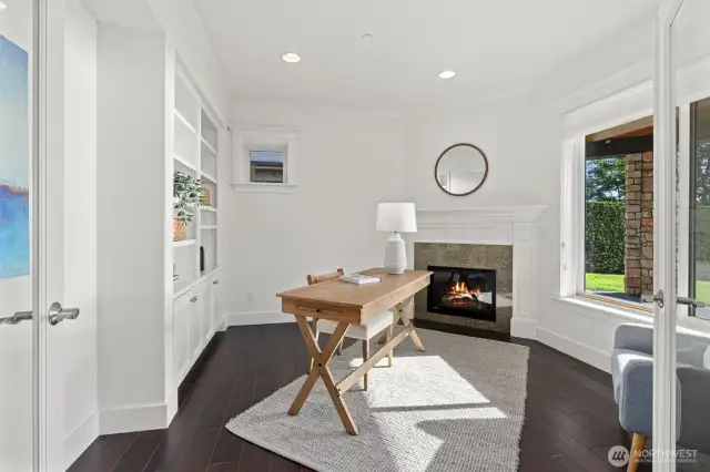 A lower-level office with a fireplace and sweeping views offers versatility - ideal for working, relaxing, or transforming into a bedroom or workout space.