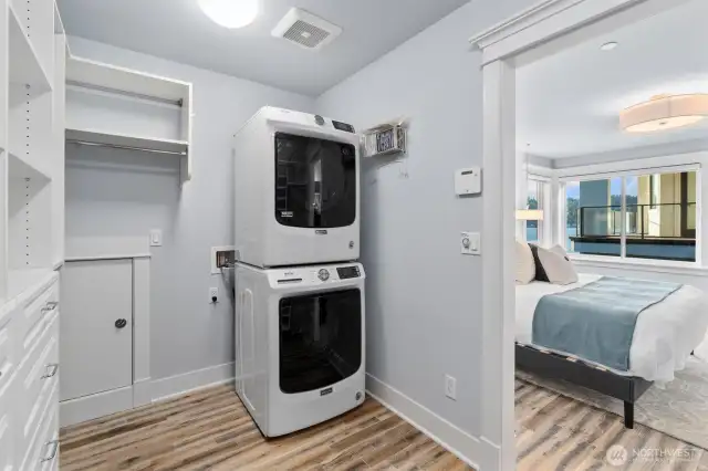 The bedroom features ample storage with a walk-in closet and an in-unit stacked washer and dryer.