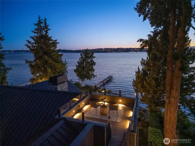 The rooftop deck offers front-row views of vibrant sunsets, the Seattle skyline, and the Olympic Mountains.