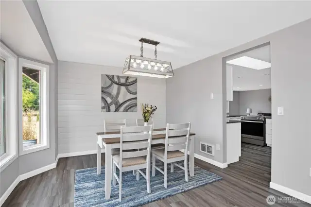Dining area just off of kitchen and living room with shiplap wall and beautiful territorial views.