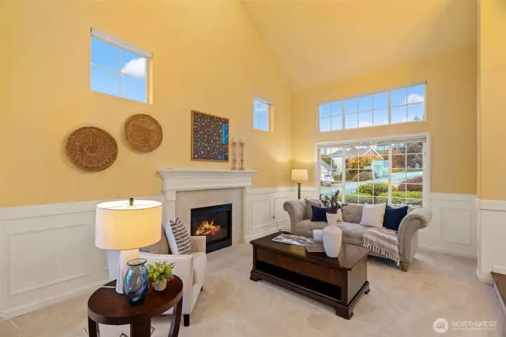 Living room with soaring ceilings and gas fireplace.