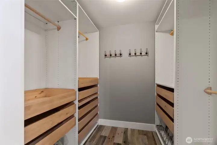 Primary walk-in closet with custom shelving.