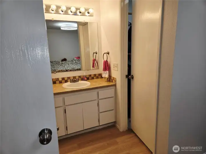 Primary bathroom with walk in bedroom closet.