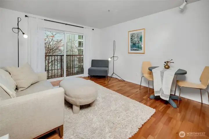 The light and bright living room with room for a full-size sofa, dining table and more