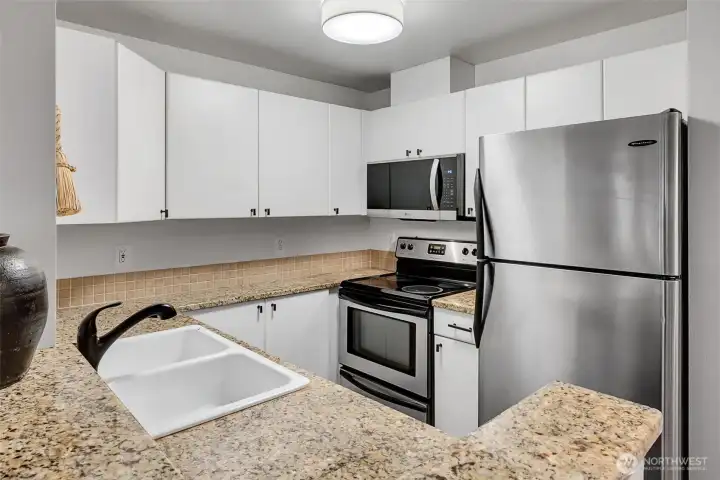 Granite counters, tile backsplash and stainless appliances