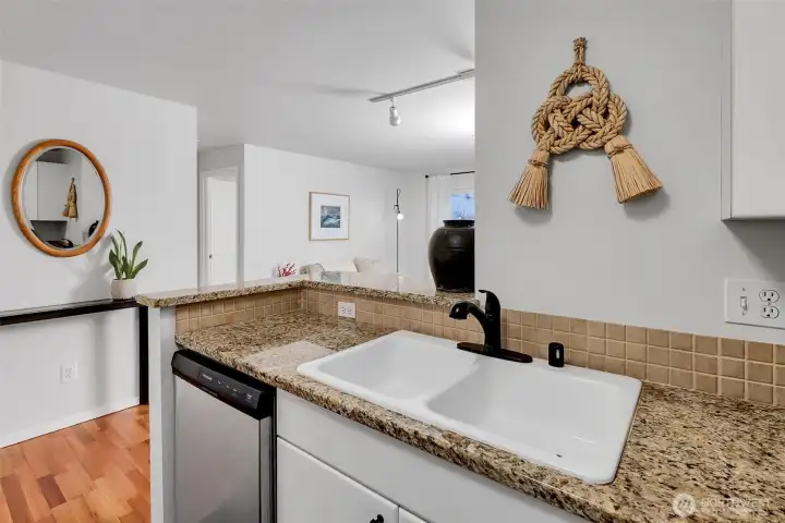 Open, bright kitchen with double sink and dishwasher