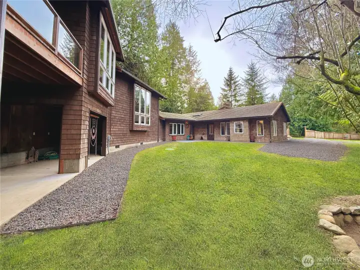 View of storage area next to barn looking at home from the barn.