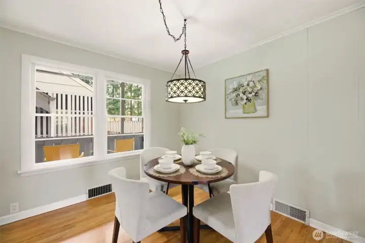 Hardwood floors, tall windows, and classic trim frame the dining room.