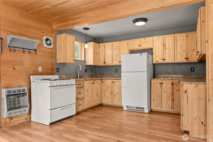 Kitchen with Granite countertops. Propane Refrigerator, stove and wall heater.
