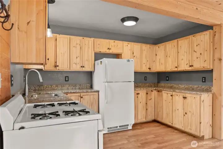 Kitchen with Granite countertops. Propane Refrigerator, stov