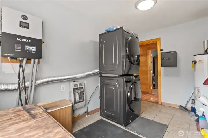 Utility room. Smart solar system to the left. Propane utilities, Washer and dryer(supplemented by solar) and hot water heater .
