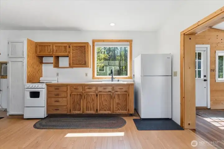 Kitchen area with stove & refrigerator.