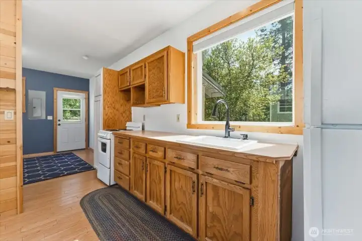 Kitchen looking towards the back door and the bedroom area.