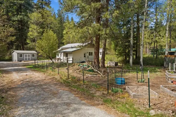 Fenced area with the home and one of the outbuildings.