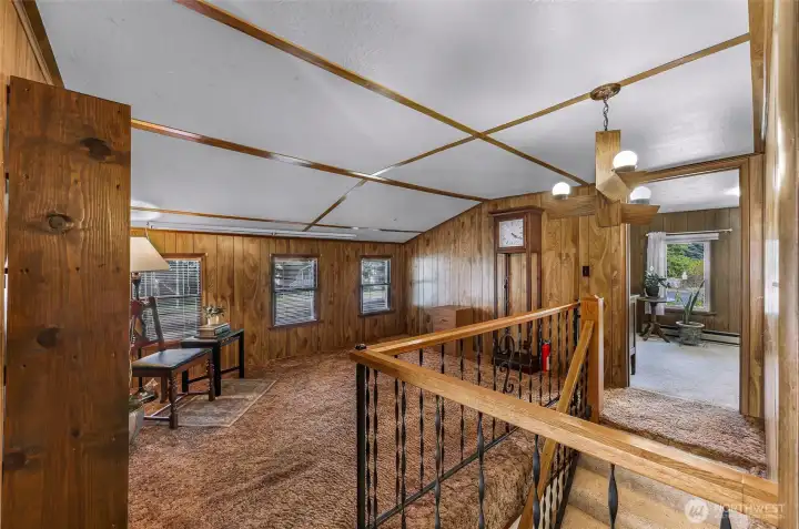 The quiet upstairs sitting area enjoys built in custom bookshelves
