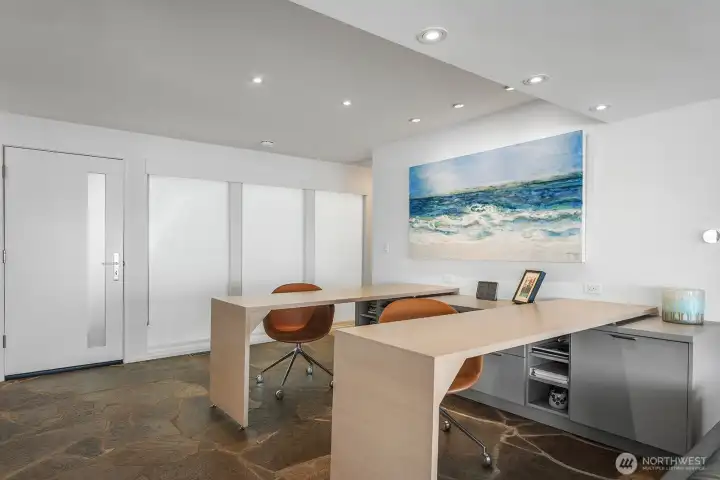 Spacious entry with obscured glass and stone flooring opens to beautifully designed flex space. The desks can be joined to create a large table for serving, crafting, or? All pieces convey and are top quality.