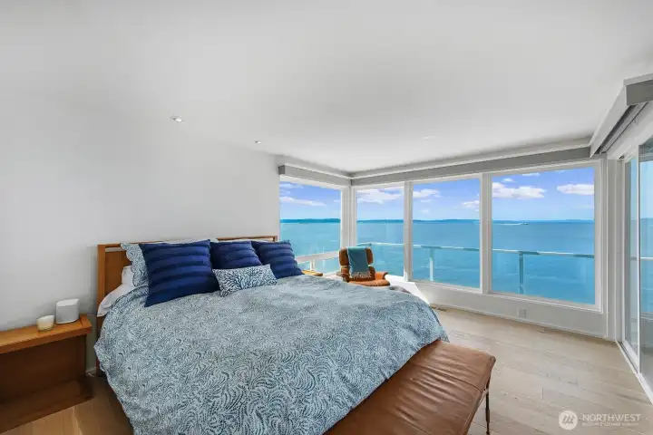 The primary suite offers sun shades, room for a seating area, ship-like views and hardwood floors.