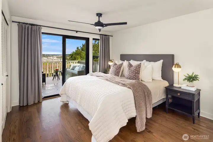 The primary bedroom has a wall of closets and access to a deck spanning the back on the house The primary bedroom has a wall of closets and access to a deck spanning the back on the house