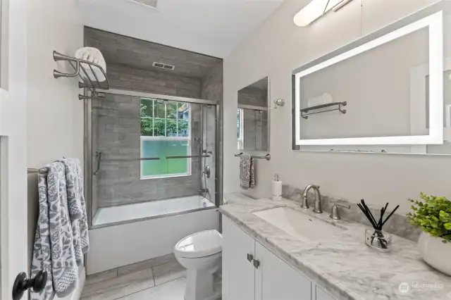 Main hall bathroom is light and bright with soothing colors.