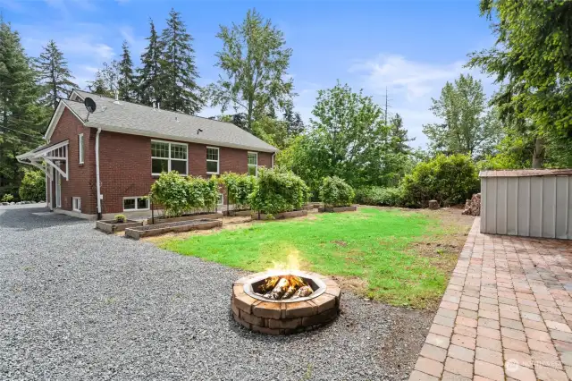 This expansive backyard beckons you to circle the fire pit with your adirondack chairs.  Lovely pavered area for a large table and chairs.  Croquet anyone!