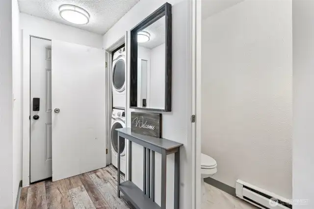 The hallway near the front door has a washer, dryer, and a half bath.