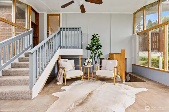 Main house, attached sun room with stairs that lead down to the paritally finished basement.
