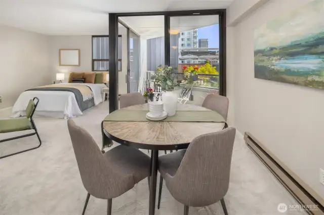 Another view of the dining area with balcony and living area