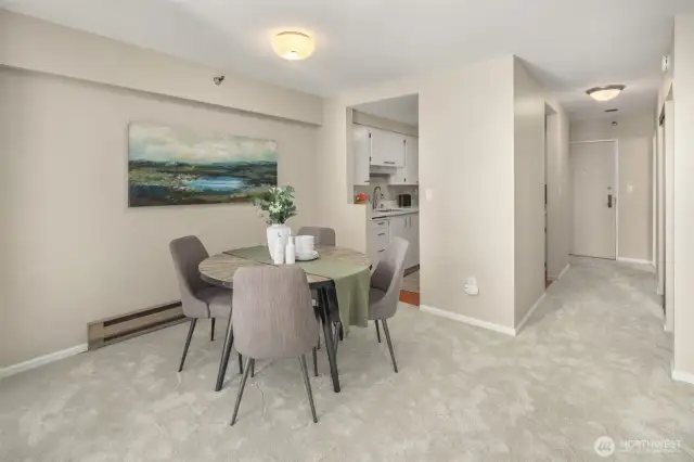 Dining area, and entry to kitchen with hallway to 3 large closets and bath. Entry at end of hall.