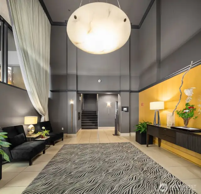 Lobby area of Harbour Heights. Elevators to the right, and mailboxes up 1/2 flight of stairs.