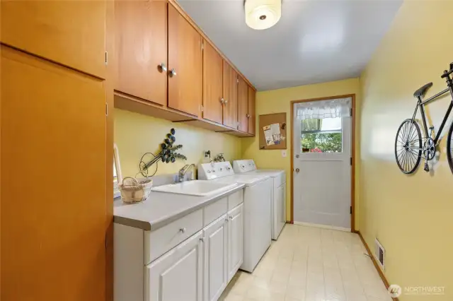 Laundry room with door to back yard